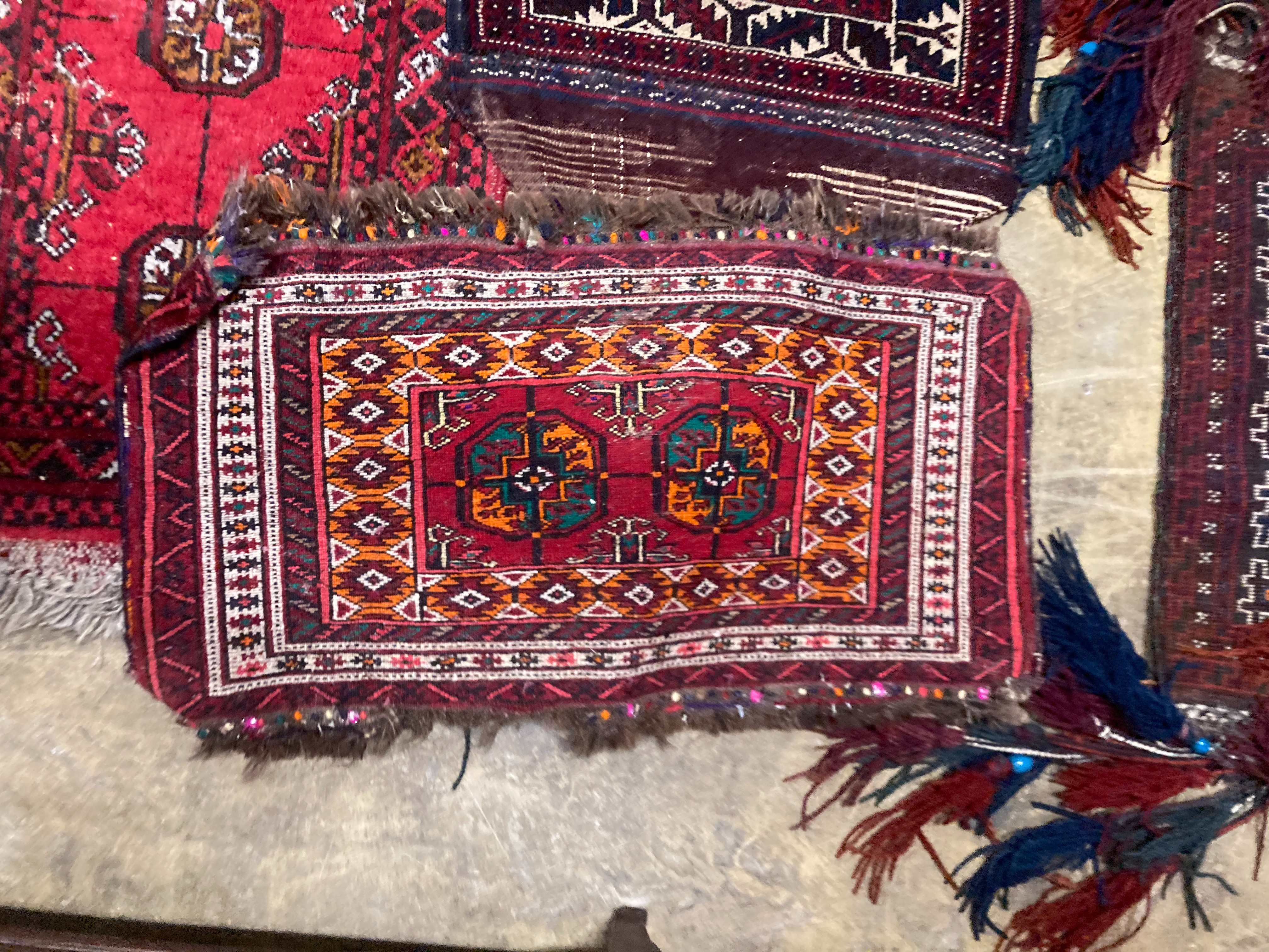A Bokhara wall hanging 54 x 70 cms, one other, two Bokhara mats and bag.